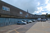 Looking the opposite way on what was the concrete platform, with the tracks on the left now filled in with tarmac. The rather shabby buildings were added in the 1950s as part of the station&#39;s facility expansion; they were quickly torn down in October 2009.